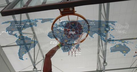 Basketball player dunking through hoop with augmented reality global analytics overlay