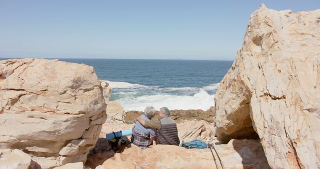 Elderly Couple Embracing on Rocky Seashore - Download Free Stock Images Pikwizard.com