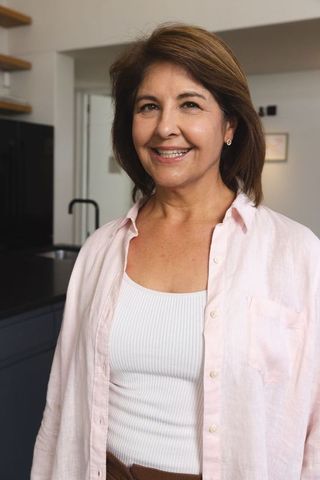 Smiling middle-aged woman in modern home kitchen