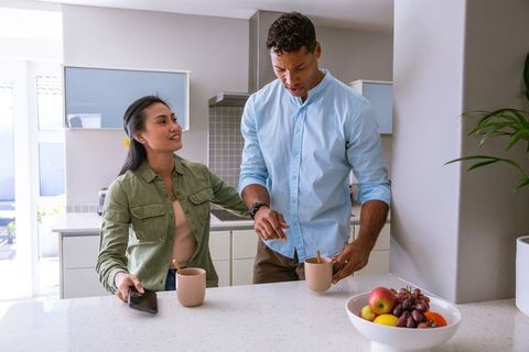 Asian Couple Enjoying Morning Coffee in Modern Kitchen