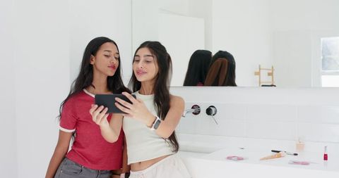 Diverse Friends Taking Selfie in Modern Bathroom