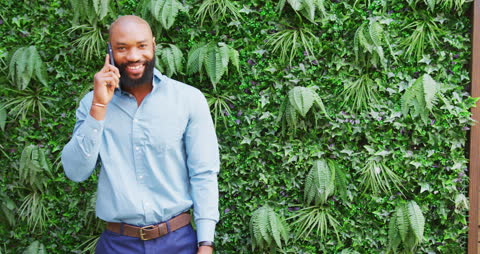 Businessman Having Phone Conversation in Green Space