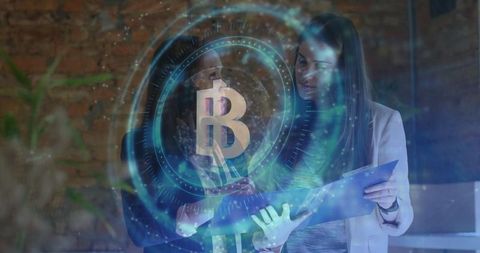 Women analyzing documents with holographic bitcoin in urban office