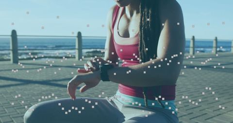 Digital Fitness Tracker on Female Athlete by Sea