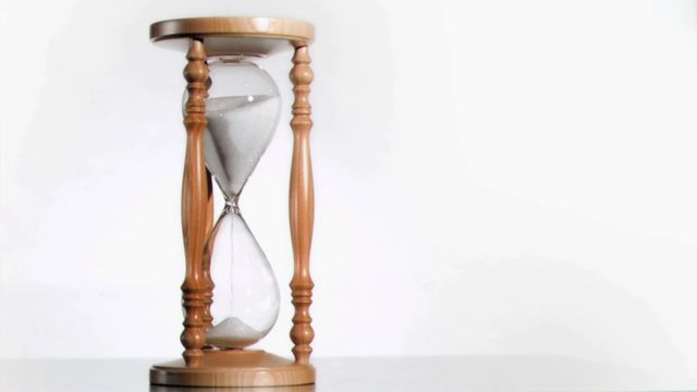 Simple and timeless hourglass with sand flowing against a white background symbolizes the passage of time. Ideal for themes related to time management, urgency, aging, or to illustrate concepts of patience and perseverance. Use in blog posts about time management strategies, website headers conveying limited time offers, or presentations focused on personal development and achievement.