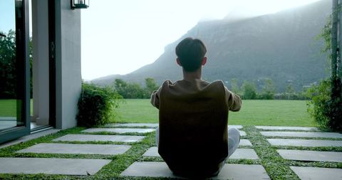 Man Enjoying Peaceful Mountain View from Modern Home