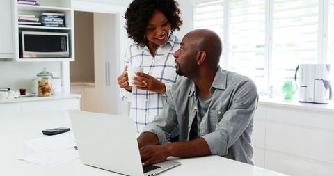 Couple Collaborating in Modern Kitchen Discussing on Laptop - Download Free Stock Images Pikwizard.com