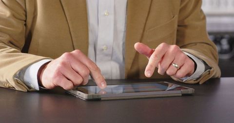 Business professional using tablet for office work