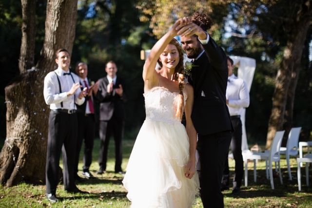 Affectionate couple dancing in park during wedding