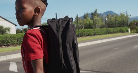 Happy Schoolboy Crosses Road Under Bright Sun - Download Free Stock Images Pikwizard.com