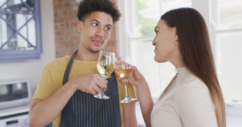 Biracial Couple Enjoying Wine Together in Kitchen - Download Free Stock Images Pikwizard.com