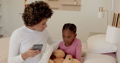 Mother Comforting Daughter with Smartphone Interaction