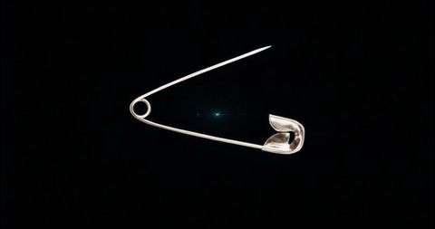 Silver Safety Pin Showing Open Coil and Reflective Shine on Black Minimalist Background