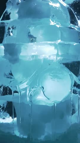 Melting Ice Sculpture Dripping Blue LED Light Revealing Translucent Orb in Vertical Video