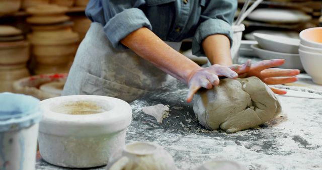 A person is skillfully shaping clay on a pottery wheel, with copy space - Download Free Stock Photos Pikwizard.com