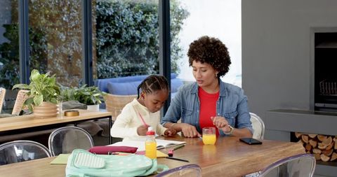 Mother and Daughter Bonding over Homework in Modern Home