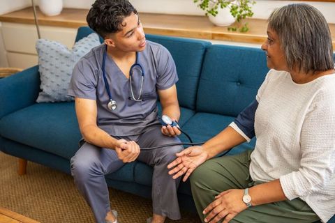Home Healthcare Professional Performing Blood Pressure Check on Senior