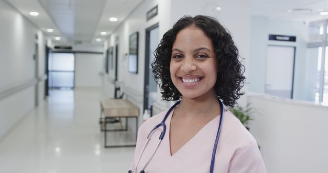 Smiling Medical Professional Standing in Hospital Corridor - Download Free Stock Images Pikwizard.com