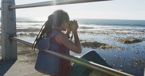 Woman Capturing Scenic Sea View on Promenade