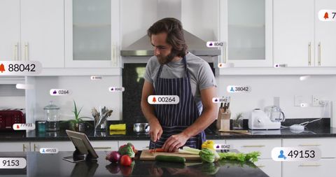 Caucasian Man Cooking at Kitchen Counter with Social Media Influences