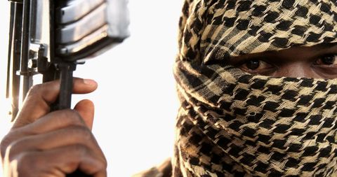 Masked Individual Holding Weapon With Intense Stare - Download Free Stock Images Pikwizard.com