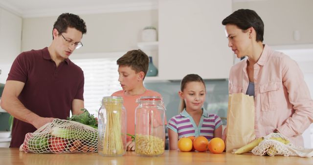 Family Unpacking Groceries in Kitchen Smiling Together - Download Free Stock Images Pikwizard.com