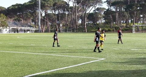 Young Soccer Players Participating in Practice Session Outdoors