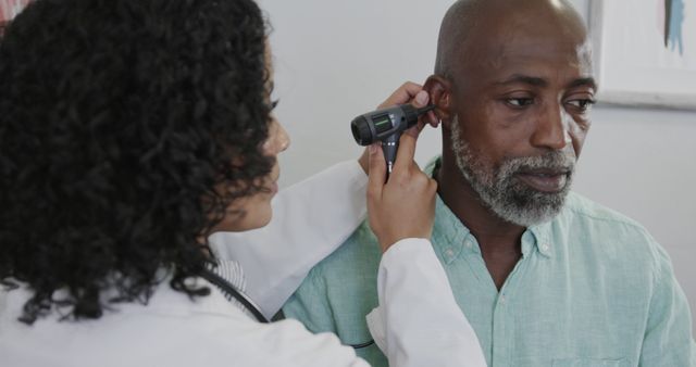 Doctor Conducting Ear Examination on Mature Male Patient - Download Free Stock Images Pikwizard.com