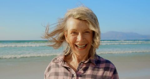 Joyful Senior Woman Smiling at Beach, Promoting Wellness