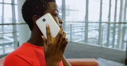 Young Afro American Man Having Phone Conversation in Modern Office