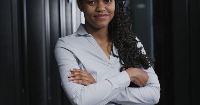 Confident African American Woman Standing with Arms Crossed in Office - Download Free Stock Images Pikwizard.com