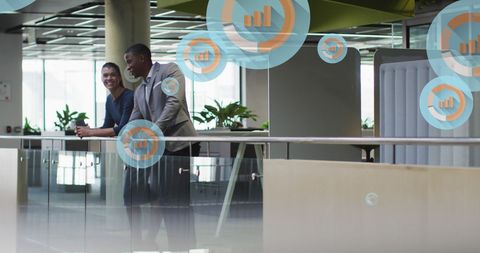 Business professionals discussing with futuristic graph interface overlay