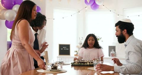 Family Celebrating Traditional Ceremony at Home With Decor