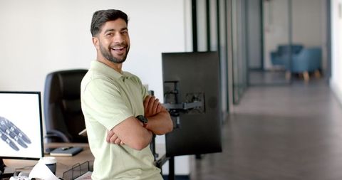 smiling engineer demonstrating robotic arm interface in modern office - Download Free Stock Images Pikwizard.com
