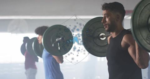 Men doing barbell squats in gym for strength and fitness