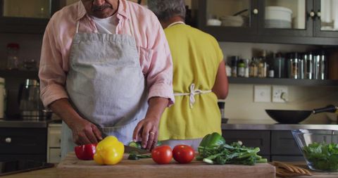 Senior Couple Enjoying Time Preparing Healthy Meal Together