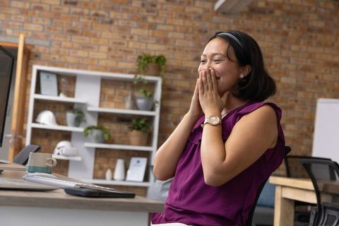 Excited Woman in Office Surprised By Good News