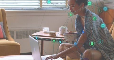 Woman using laptop at home with e-commerce graphic overlay