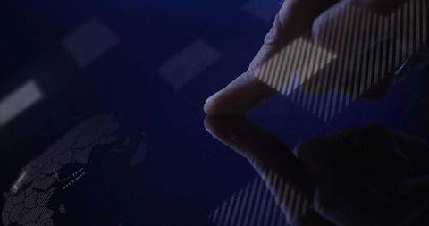 Fingertip Touching Dark Touchscreen with World Map Data Overlay and Reflective Interface