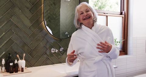 Elderly Woman Smiling in Stylish Modern Bathroom