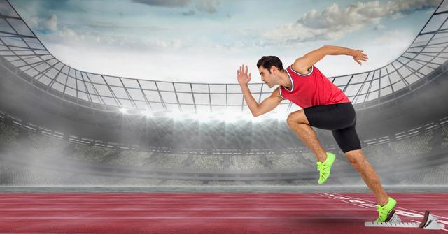 Male athlete dressed in red tank top and black shorts starting to sprint from starting blocks on a professional track. Modern stadium with large audience seats and dramatic cloudy sky in background. Potential uses include promoting athletic events, sports gear, motivational posters, fitness training programs, and inspirational content.