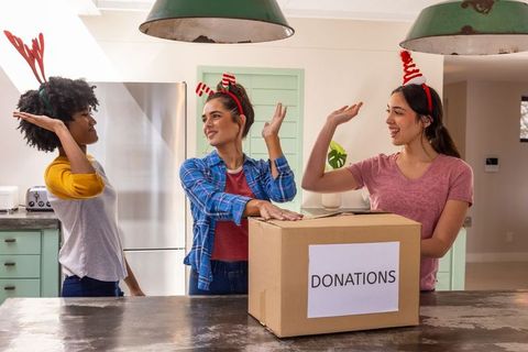 Festive Friends Preparing Donation Box in Holiday Spirit