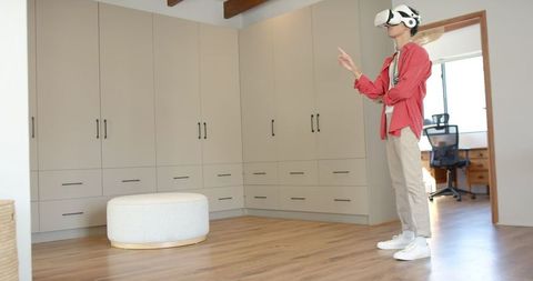 Young Man Experiencing Virtual Reality in Modern Dressing Room