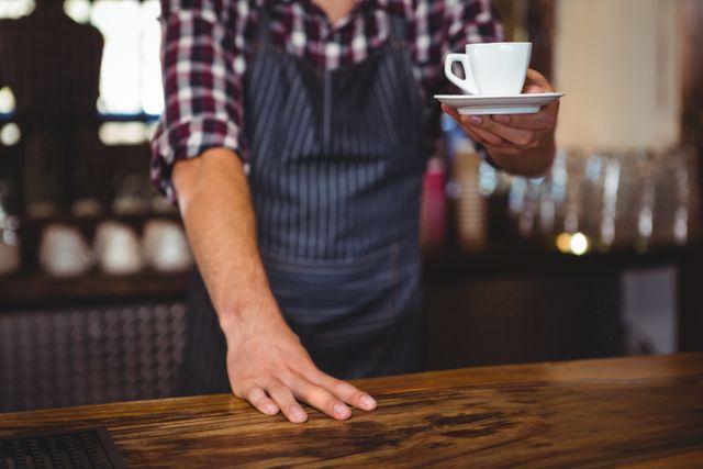 Waiter handing over a coffee in a restaurant