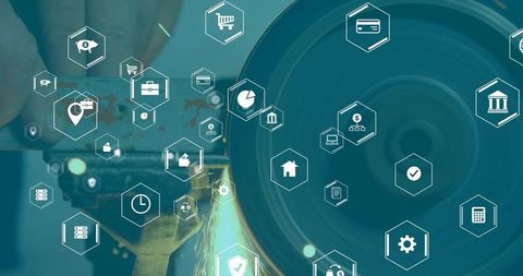 Workshop grinding wheel with gloved hand and finance tech overlay representing industry 4.0