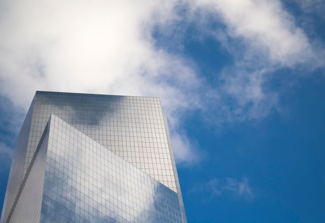 Modern Skyscraper Against Blue Sky with Clouds - Download Free Stock Photos Pikwizard.com