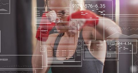 Female Boxer Punching with Red Gloves and HUD Data Overlays for Fitness Tech Concept