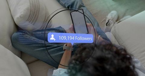 Influencer growth concept holding smartphone showing 109,194 followers overlay on sofa