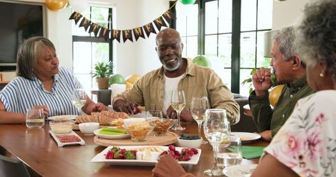 Joyful Senior Friends Celebrating Retirement at Home Party