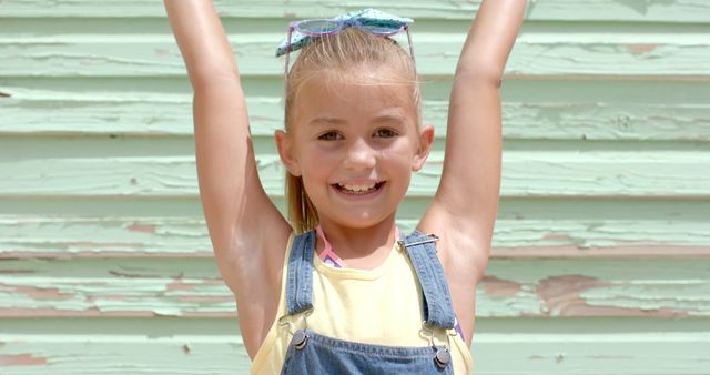 Happy Young Girl Wearing Overalls Posing Against Weathered Wall - Download Free Stock Images Pikwizard.com